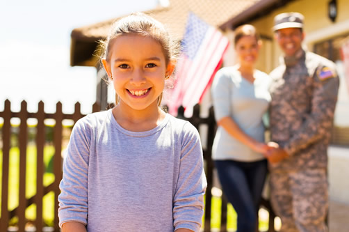 Military family in front of house